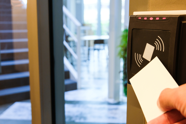 Worker using electronic keycard to access secure area